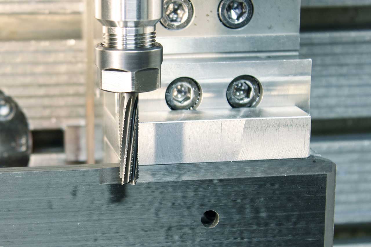 The picture shows a solid carbide end mill from MAPAL in use when machining a CFRP material.