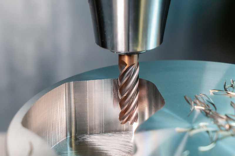 An OptiMill-Tro-Inox trochoidal milling cutter machinges a stainless steel component on the machine.