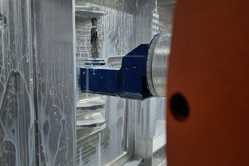 Boring the lugs using an angle head with a solid carbide step drill.