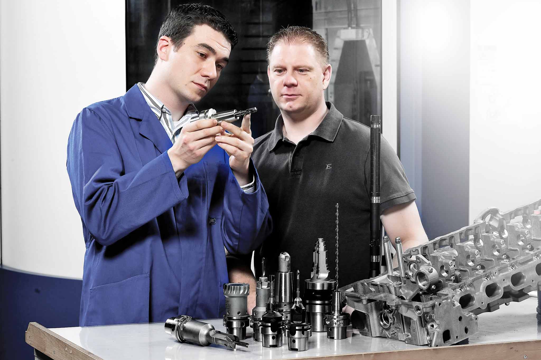 Two MAPAL specialists discuss a customer's modification request.