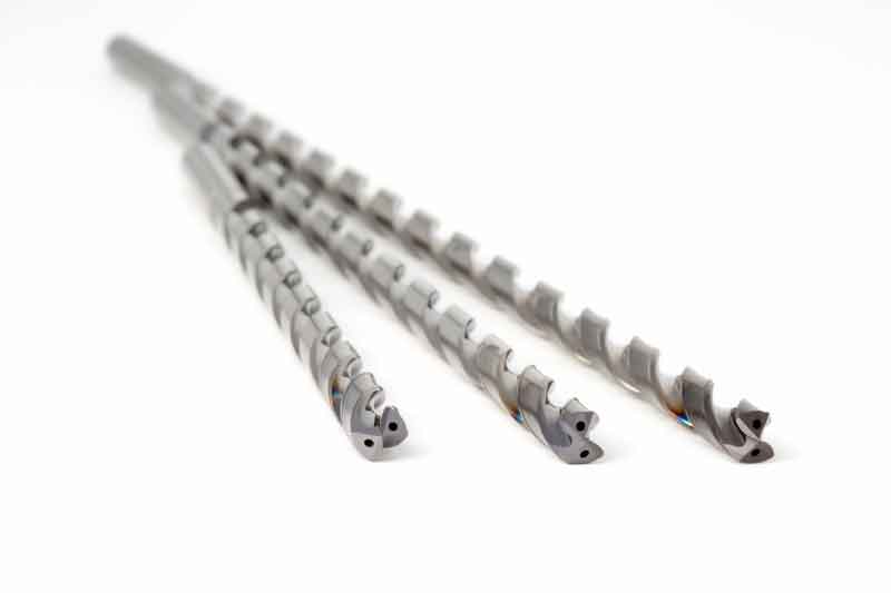 Three variants of the MEGA Deep Drill Steel in different lengths are on display.