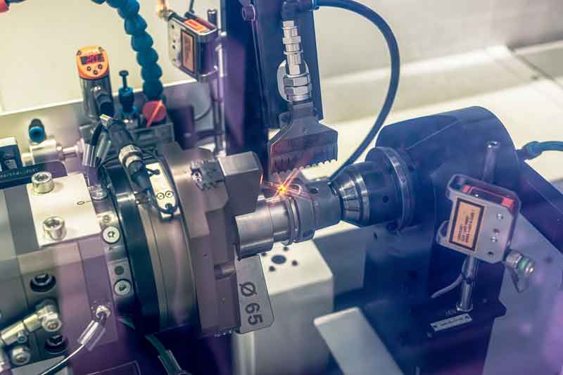The picture shows a close-up of a clamped HSK being processed with the laser.